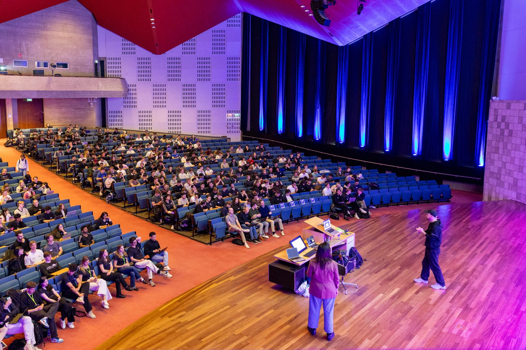 Speaker on stage at a packed ETC event