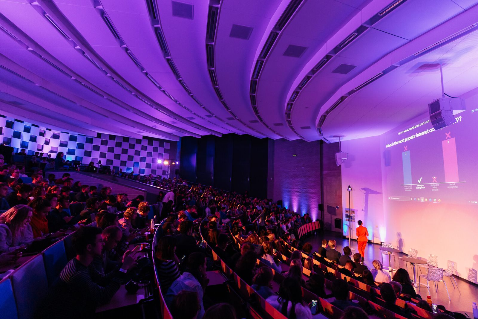 Students seated in a lit event hall at an ETC evening event